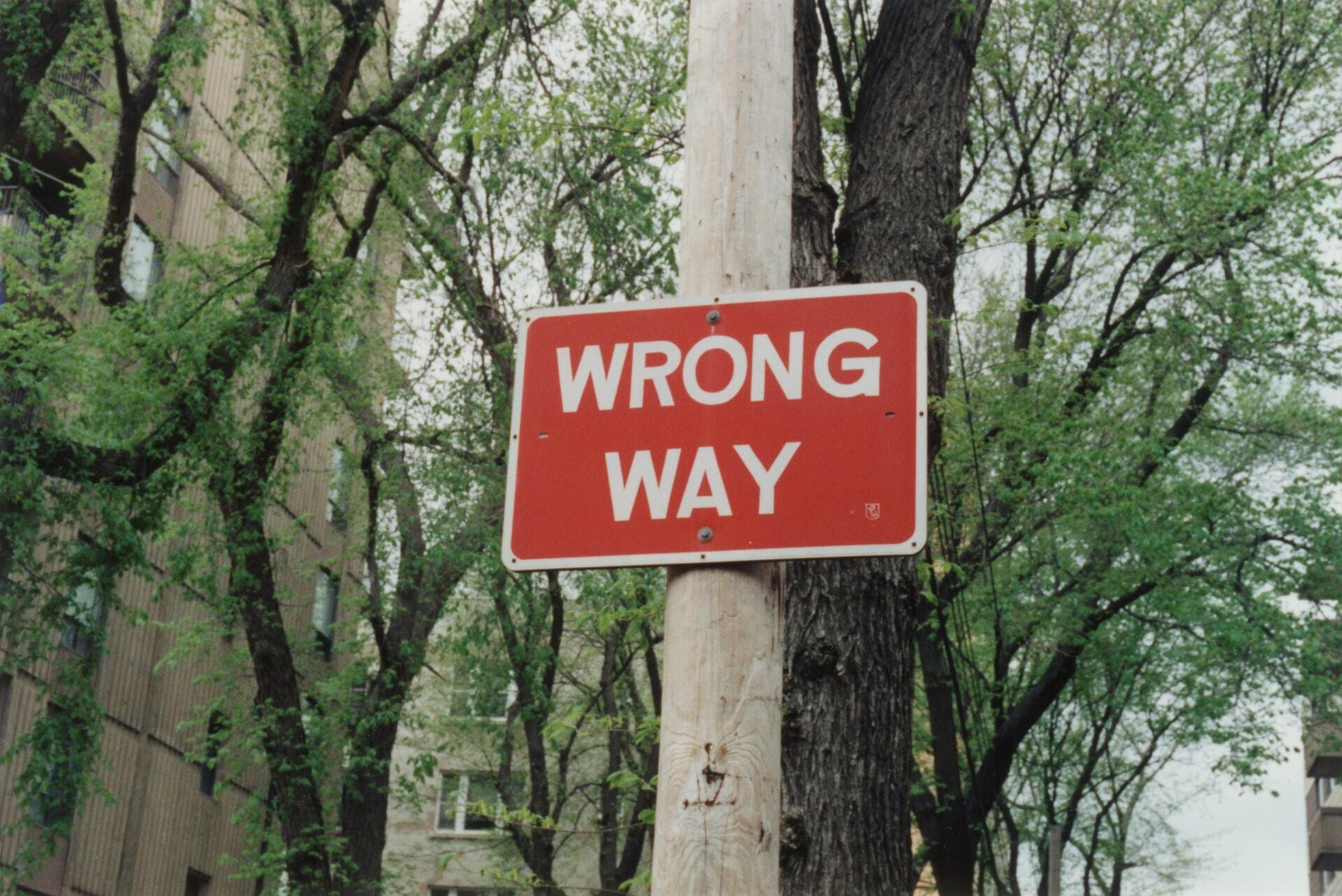 wrong way sign - Employee Misclassification: How to Avoid Contractor Classification Risk